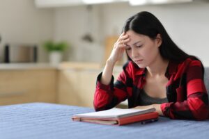 Woman struggling to focus while studying, ADHD testing Colorado Springs