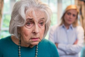 Elderly woman looking confused at home while daughter watches, early signs leading to dementia evaluation Colorado Springs.